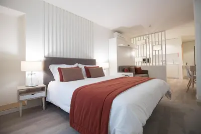 a bedroom with a large bed with a red blanket at Almada Wine House - Tourism Apartments in Porto