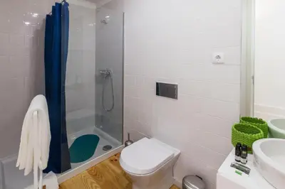 a bathroom with a shower and a toilet and a sink at Home Alegria in Porto