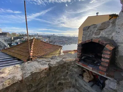a brick oven sitting on top of a building at Casa Dona Olga River View in Porto