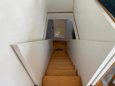 a staircase in a room with white walls and wooden floors at Casa Dona Olga River View in Porto