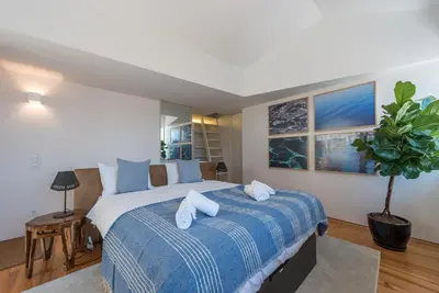 a bedroom with a large bed with a blue blanket at Casa Dona Olga River View in Porto