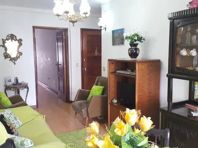 a clock hanging on a wall next to a table at Apartment Rustic Oporto in Porto