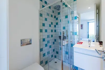 a bathroom with a shower and a toilet and a sink at Sunny Home in Porto