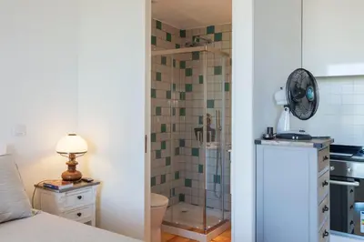a bathroom with a shower with a glass door at Sunny Home in Porto