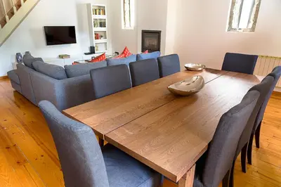 a dining room with a wooden table and chairs at Casa da Oliveira in Porto