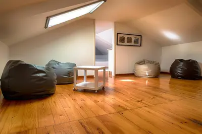 a room with a table and two bean bags at Casa da Oliveira in Porto