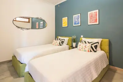 two beds in a room with a mirror on the wall at Merc Porto Ribeira's Up place in Porto