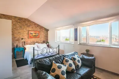 a living room with a couch and a bed at Merc Porto Ribeira's Up place in Porto