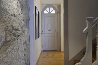 a hallway with a white door with a window at OportoHouse in Porto