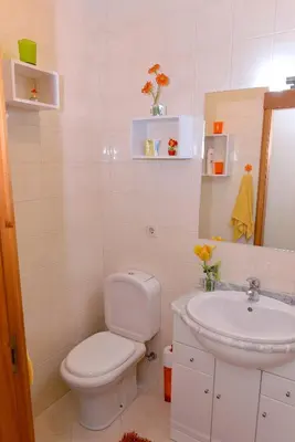 a white bathroom with a toilet and a sink at Apartamento Porto Centro in Porto
