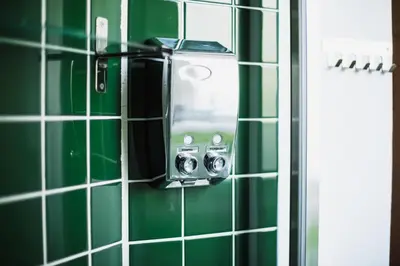 a mirror in a green tiled bathroom at Bonjardim Terrace in Porto