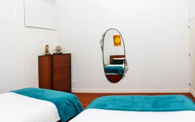 a bedroom with two beds and a mirror at Bonjardim Terrace in Porto