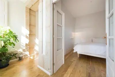 a bedroom with a bed and an open door at BmyGuest - Porto Design Central Apartment in Porto