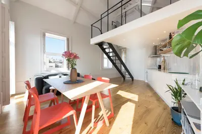 a kitchen and dining room with a table and chairs at BmyGuest - Porto Design Central Apartment in Porto