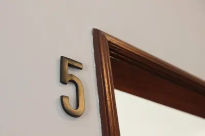 a number on a wall with a wooden frame at AC House in Porto