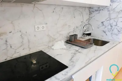 a white marble kitchen counter with a sink at Lovely Porto in Porto