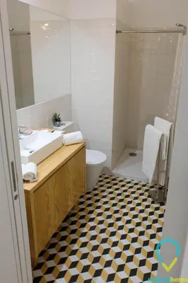 a bathroom with a sink and a toilet and a mirror at Lovely Porto in Porto