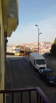 a bus and a van parked in a parking lot at Casinha Miradouro in Vila Nova de Gaia