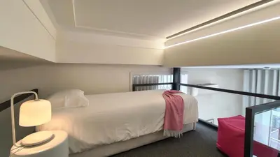 a white bedroom with a bed and a mirror at Domus 21 - Entreparedes in Porto