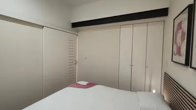 a hallway with a black door and a room with two beds at Domus 21 - Entreparedes in Porto