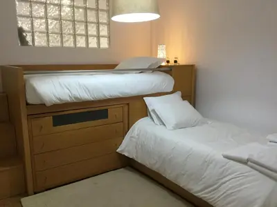 a bedroom with two bunk beds and a laptop on top at My Portugal for All - Oporto Flat in Vila Nova de Gaia