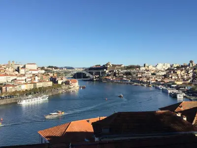 a view of a river with boats in a city at My Portugal for All - Oporto Flat in Vila Nova de Gaia