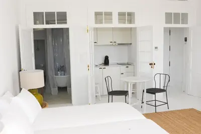 a white room with a bed and a table and chairs at Mo House in Porto