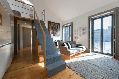 a staircase in a living room with a couch at Bom-Jardim Trindade in Porto