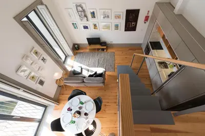 an overhead view of a living room with a table and stairs at Bom-Jardim Trindade in Porto