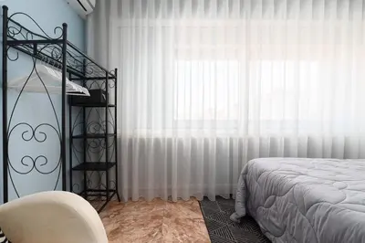 a bedroom with a bed and a large window at Porto Downtown Apartment in Porto