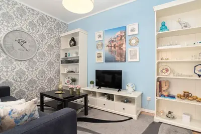 a living room with a couch and a tv at Porto Downtown Apartment in Porto