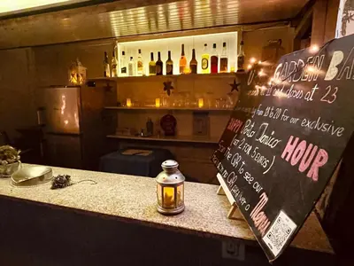 a bar with a sign and a counter with bottles of wine at Firmeza 358 studios - street level in Porto
