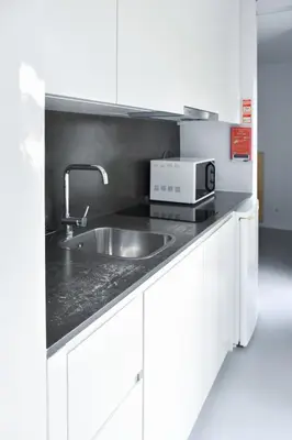 a kitchen with a sink and a microwave at I Loft Porto in Porto
