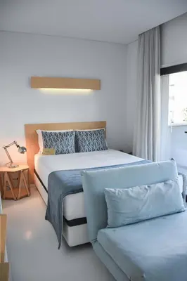a bedroom with a large bed and a window at I Loft Porto in Porto