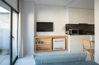 a living room with a blue couch and a kitchen at I Loft Porto in Porto
