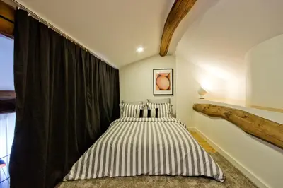 a bedroom with a bed and a large window at Oliveirinhas Porto Apartment in Porto