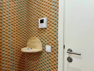 a bathroom with a toilet with a mirror on the wall at Light-Filled Apartment with Garden • Downtown in Porto