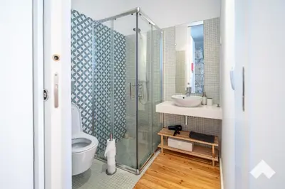 a bathroom with a shower and a toilet and a sink at Bright Apartment • Downtown Porto in Porto