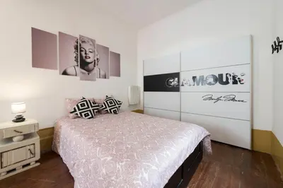 a bedroom with a bed and some pictures on the wall at BmyGuest - 156 Trindade House & Terrace in Porto