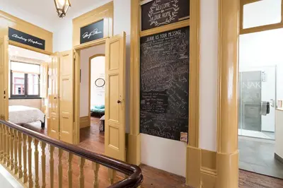 a room with a chalkboard on the wall and a staircase at BmyGuest - 156 Trindade House & Terrace in Porto