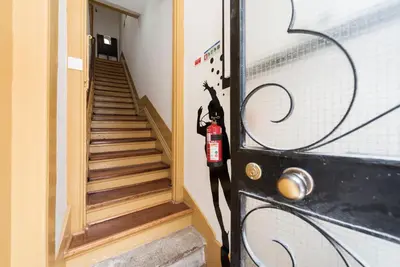 a black door with a black cat standing on it at BmyGuest - 156 Trindade House & Terrace in Porto