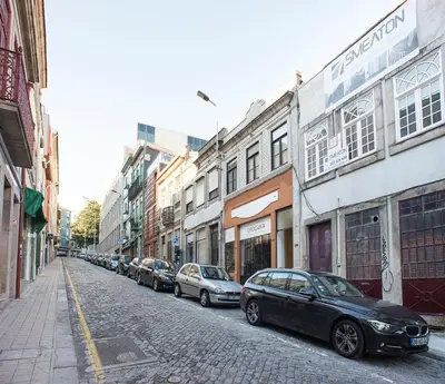 a row of cars parked on a city street at BmyGuest - 156 Trindade House & Terrace in Porto