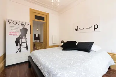 a bedroom with a bed and a sign on the wall at BmyGuest - 156 Trindade House & Terrace in Porto