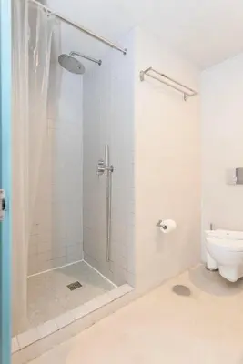 a bedroom with a large white bed with two windows at Liiiving in Porto - Santa Catarina Luxury Apartment in Porto