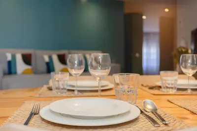 a book sitting on a table next to a bowl at Liiiving in Porto - Santa Catarina Luxury Apartment in Porto