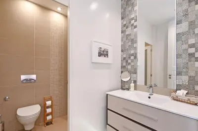 a bathroom with a white sink and a toilet at Inn Oporto Old Town Apartments in Porto