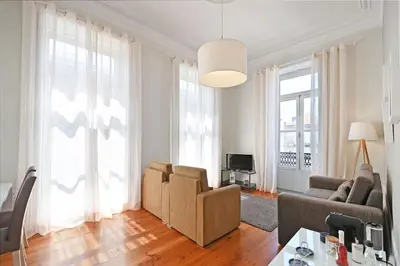 a living room with a couch and a chair at Inn Oporto Old Town Apartments in Porto