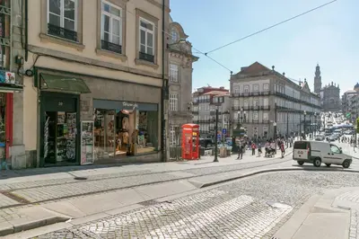 a street with a red phone booth on a city street at Inn Oporto Old Town Apartments in Porto