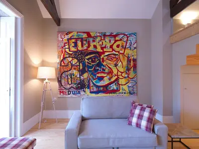 a living room with a couch and a painting on the wall at Oporto Medusa Apartment in Porto