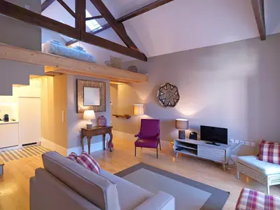 a living room with a couch and a tv at Oporto Medusa Apartment in Porto